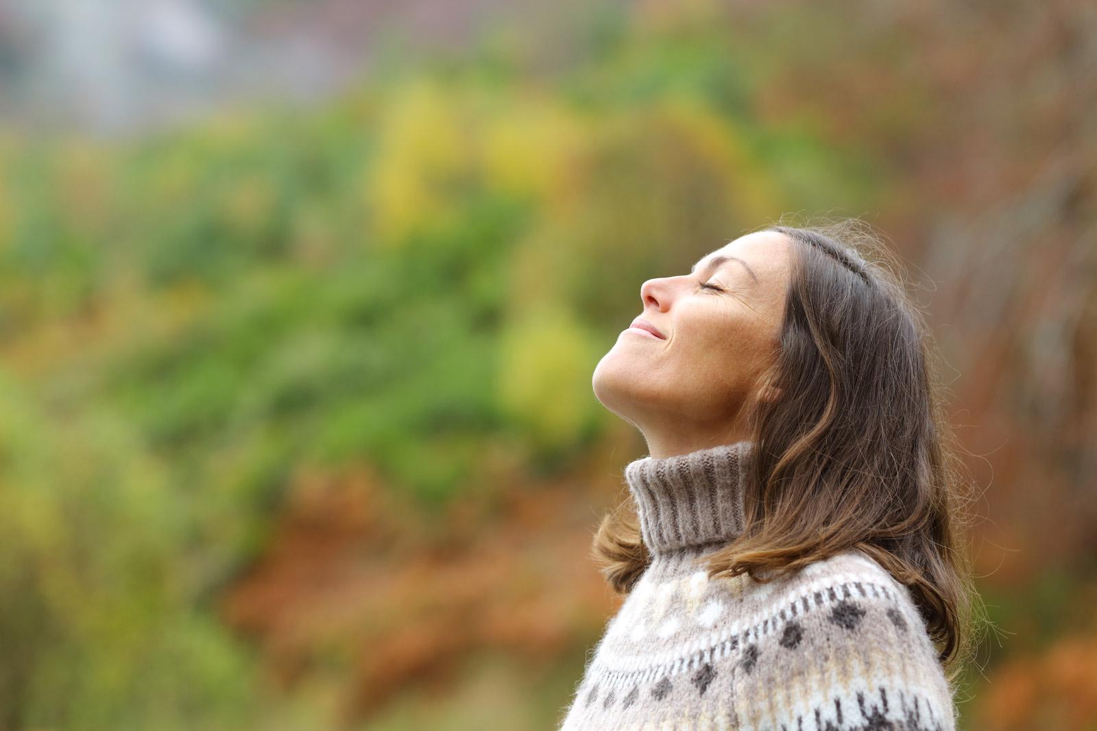 Woman meditating in the woods.