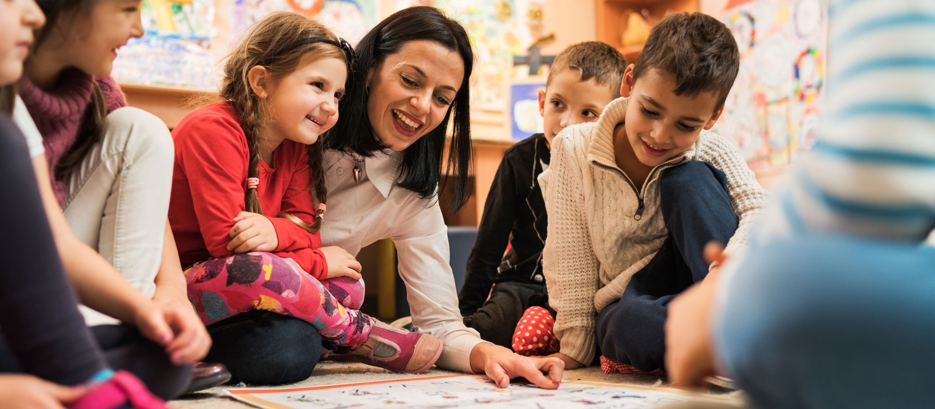 Daycare provider playing with children