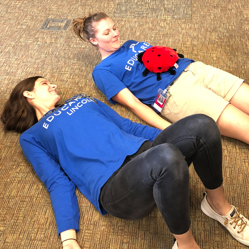 Educators participating in a belly breathing exercise.