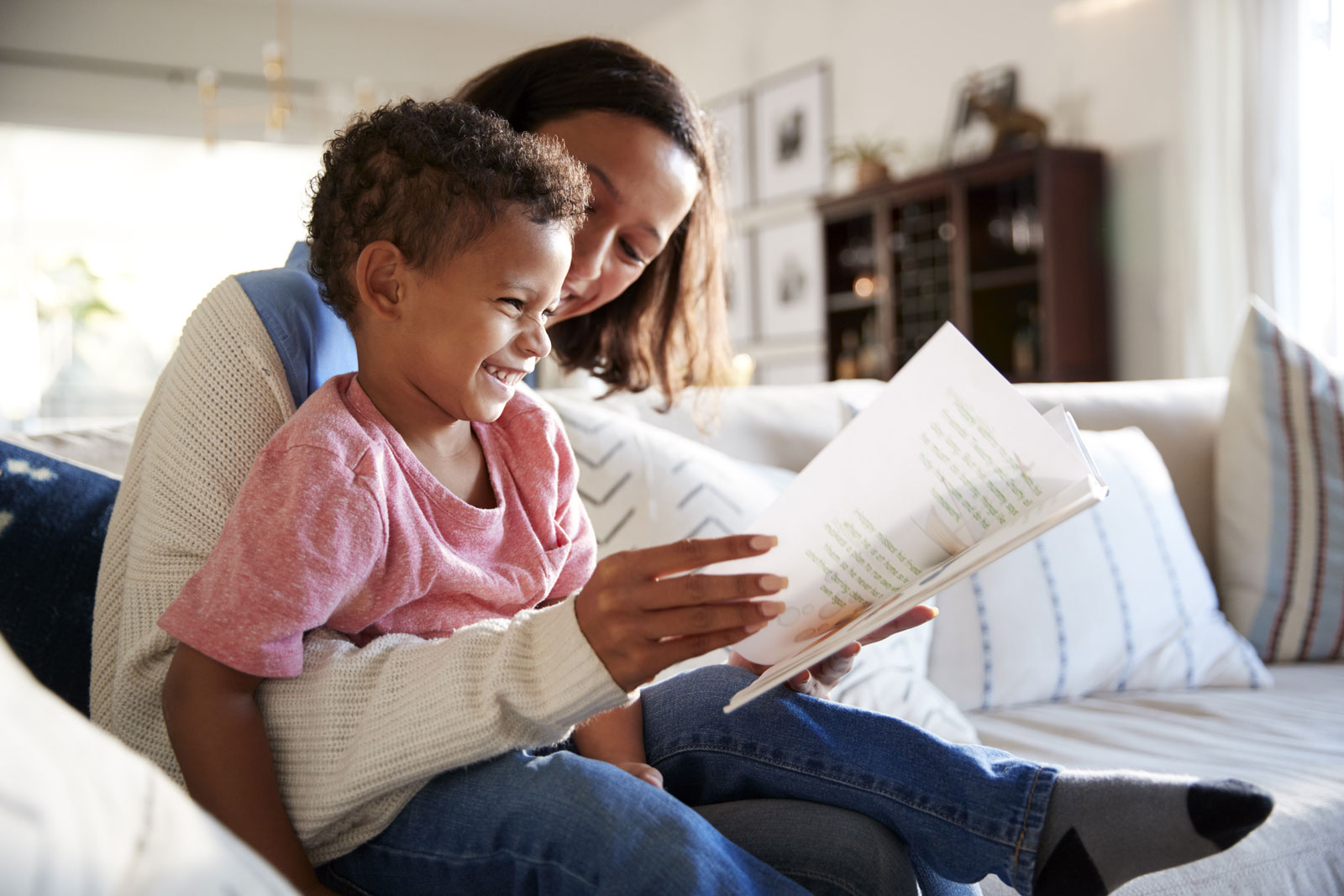 Boy reading with mom on the couch