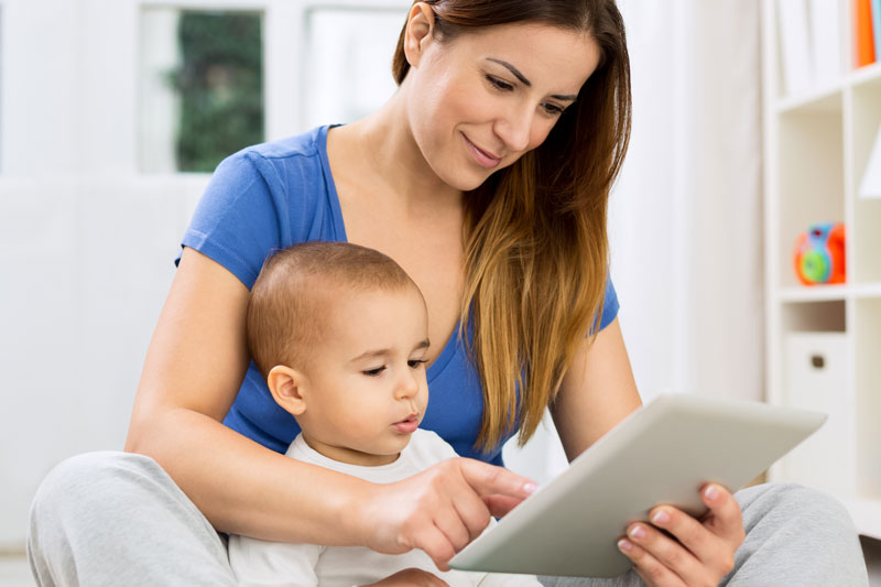 Woman looking at an iPad with her son