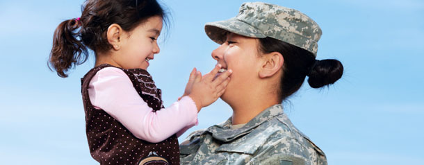 Military woman holding child