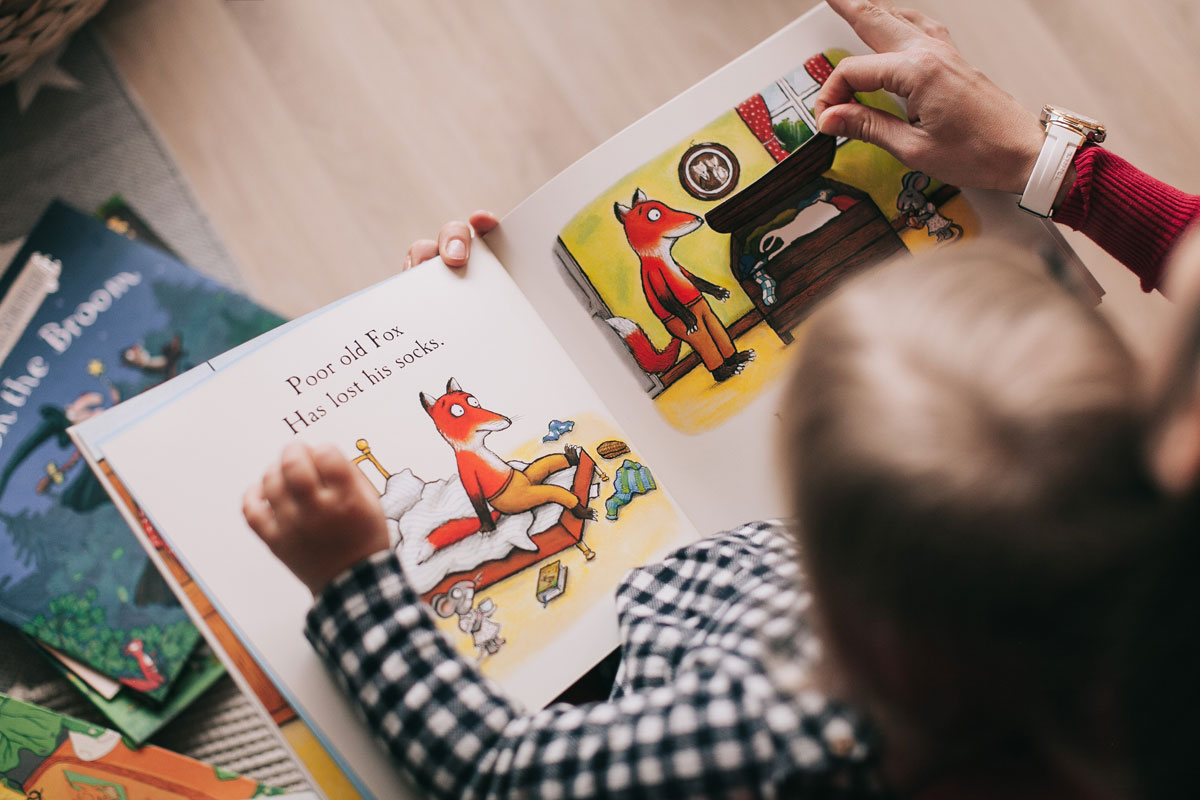 An opened book on a child's lap