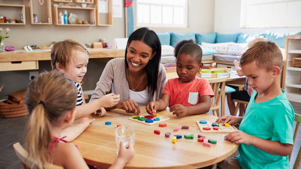 Daycare teacher playing with students