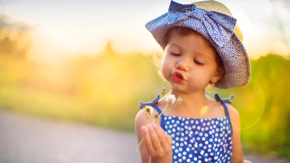 Child holding a flower