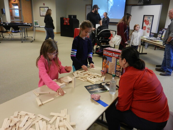 Group of children and adult playing with blocks