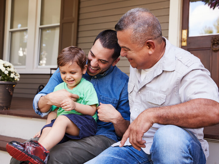 Father, Grandfather, and toddler sitting on porch steps