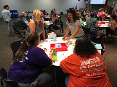 Group of educators sitting around a table at a training