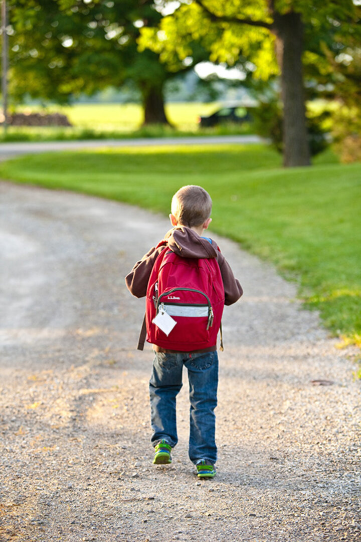A child walking with a backpack