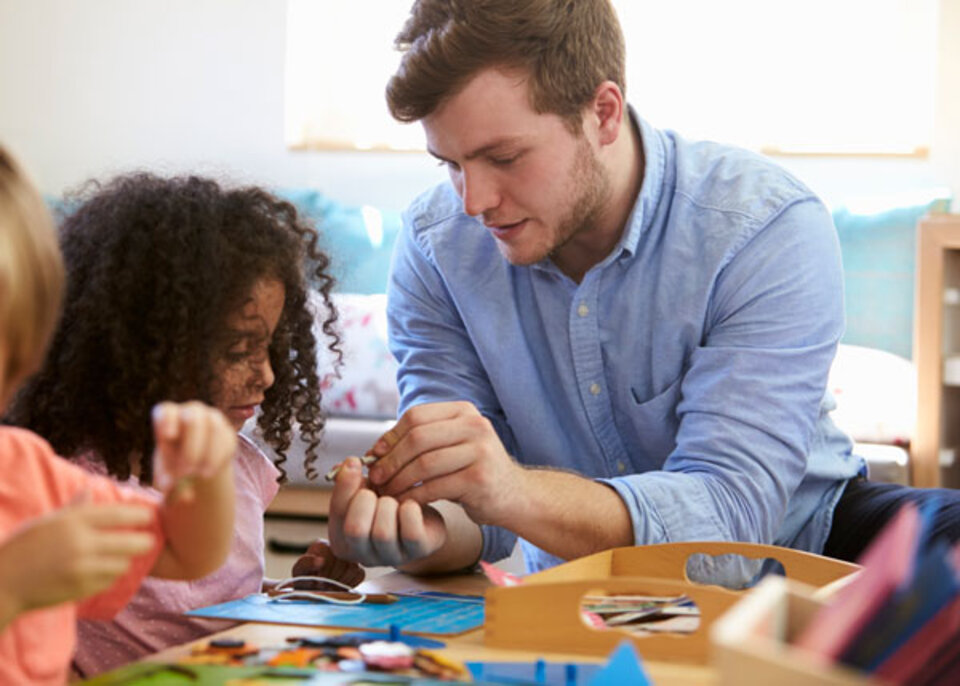 Children and caregiver playing at daycare